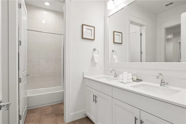 a bathroom with a shower sink and mirror