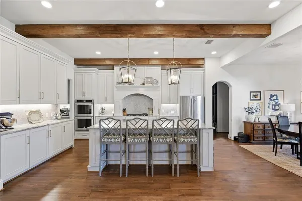 a kitchen with sink cabinets and wooden floor