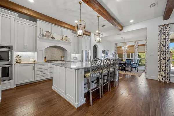 a kitchen with stainless steel appliances granite countertop a sink and cabinets