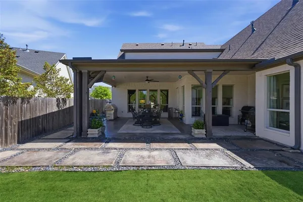 a view of a backyard with a slide trees and wooden fence