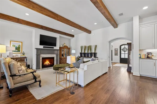 a living room with lots of furniture and wooden floor