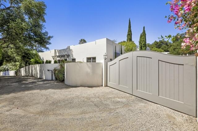 780 Mission Canyon Road Santa Barbara, CA 93105 - Photo 2 of 97 a view of a white house with a yard and large tree