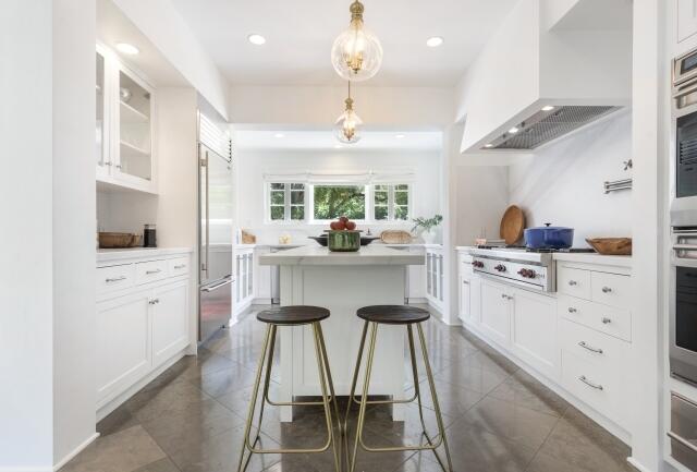 780 Mission Canyon Road Santa Barbara, CA 93105 - Photo 25 of 97 a kitchen with stainless steel appliances kitchen island granite countertop a stove a refrigerator and a dining table with white cabinets