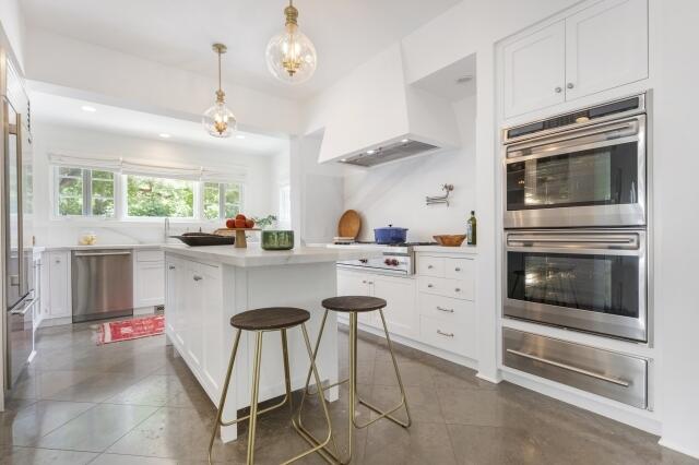 780 Mission Canyon Road Santa Barbara, CA 93105 - Photo 26 of 97 a kitchen with stainless steel appliances kitchen island granite countertop a stove a sink and a refrigerator with wooden floors
