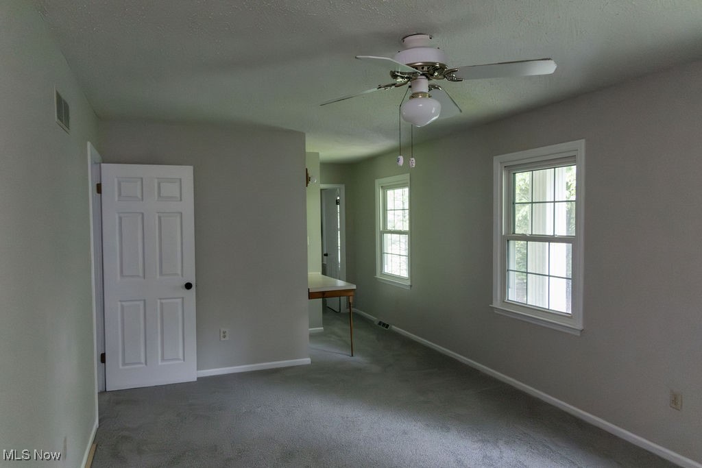 3333 Dayton Road Madison, OH 44057 - Photo 31 of 48 Unfurnished room with baseboards, a ceiling fan, carpet flooring, and a textured ceiling
