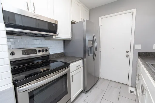a kitchen with appliances and cabinets