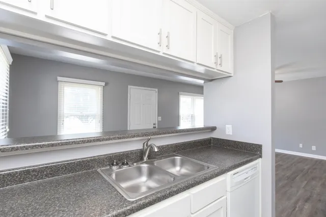 a kitchen with granite countertop a sink and a window