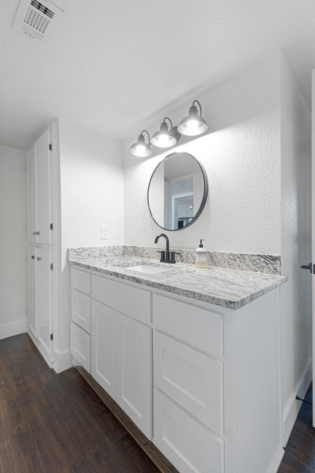 1307 Nix Road Lampasas, TX 76550 - Photo 13 of 30 a bathroom with a granite countertop double vanity sink and a mirror