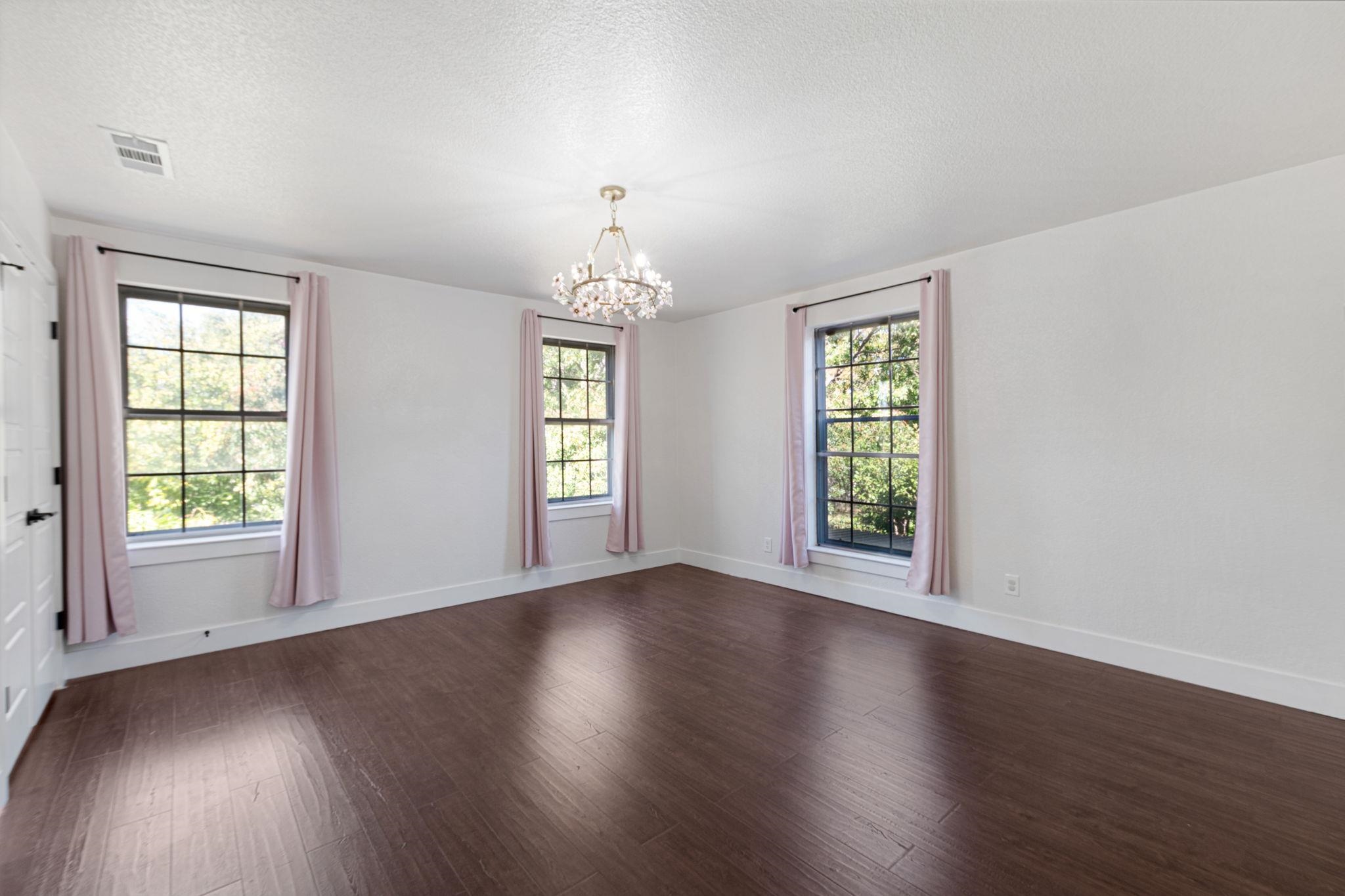 1307 Nix Road Lampasas, TX 76550 - Photo 16 of 30 an empty room with wooden floor and windows