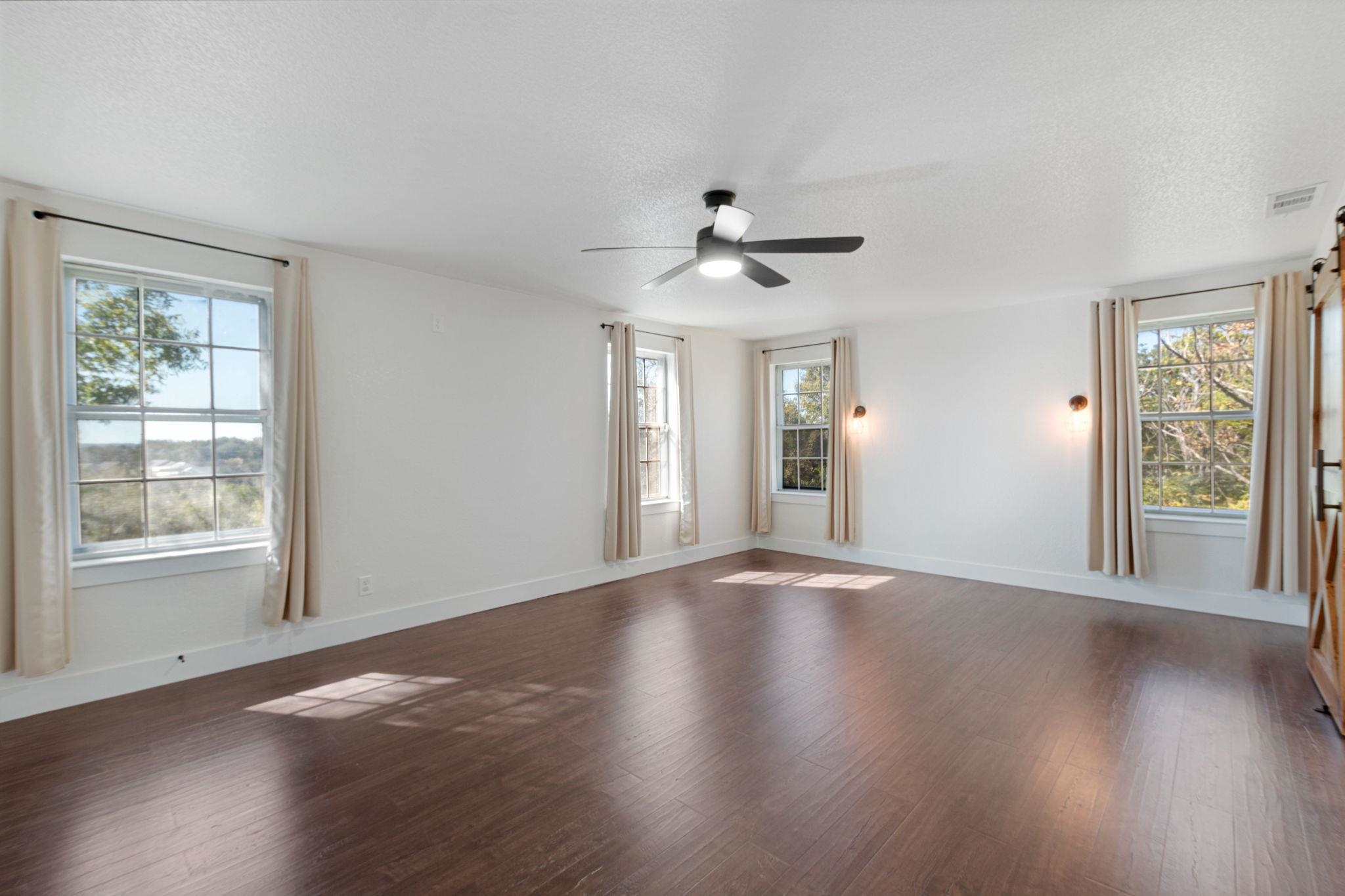 1307 Nix Road Lampasas, TX 76550 - Photo 20 of 30 a view of an empty room with wooden floor and a window