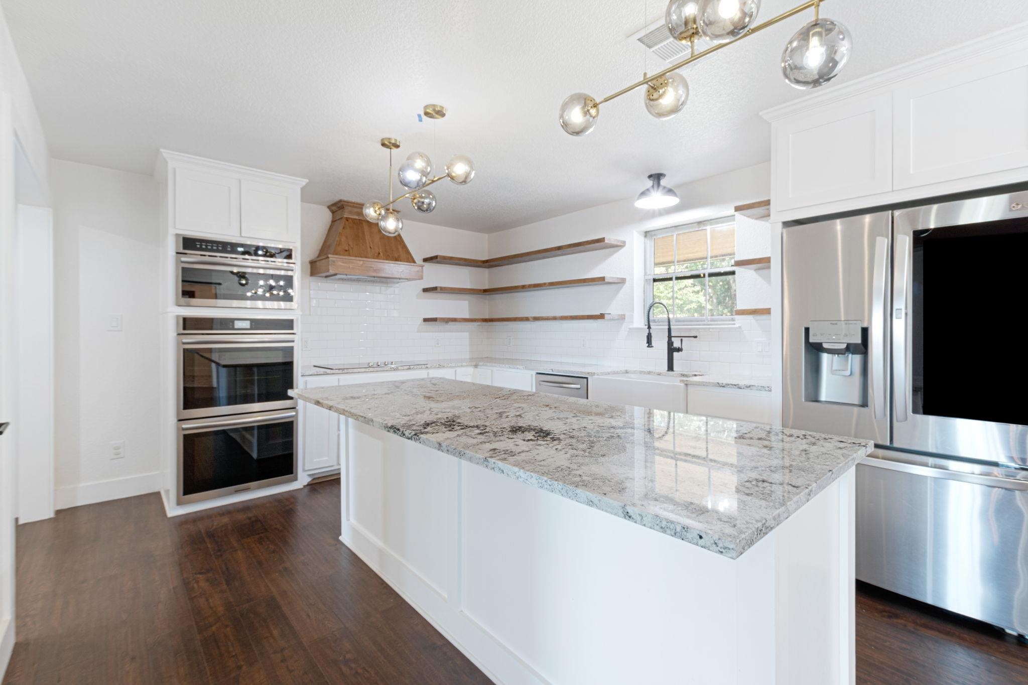 1307 Nix Road Lampasas, TX 76550 - Photo 7 of 30 a kitchen with kitchen island a counter space a sink and stainless steel appliances