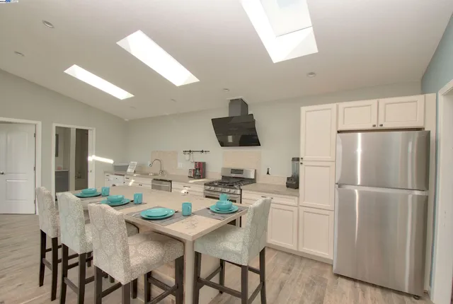 a kitchen with refrigerator and microwave