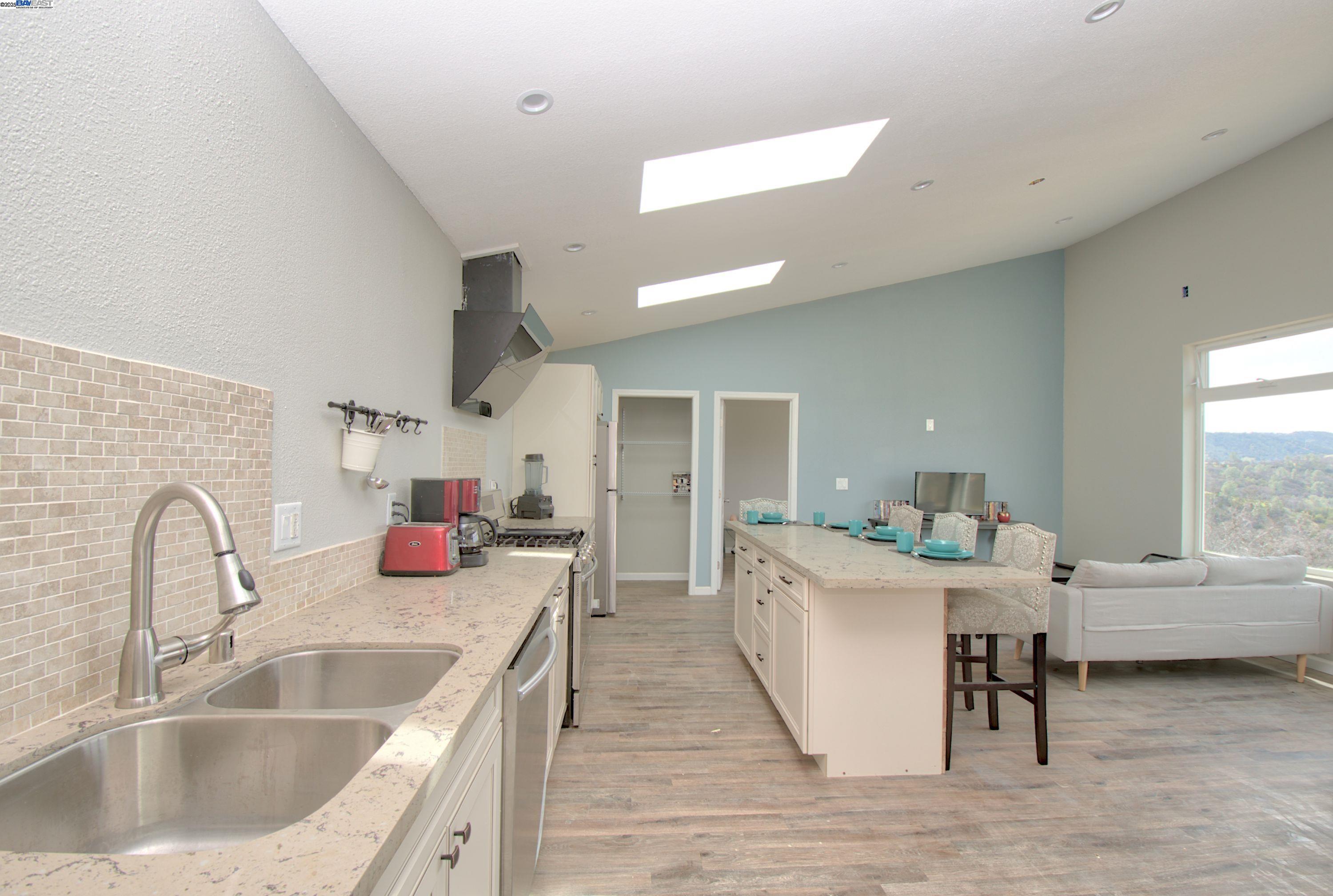 19990 Mines Road Livermore, CA 94550 - Photo 7 of 18 a kitchen with a sink and a refrigerator