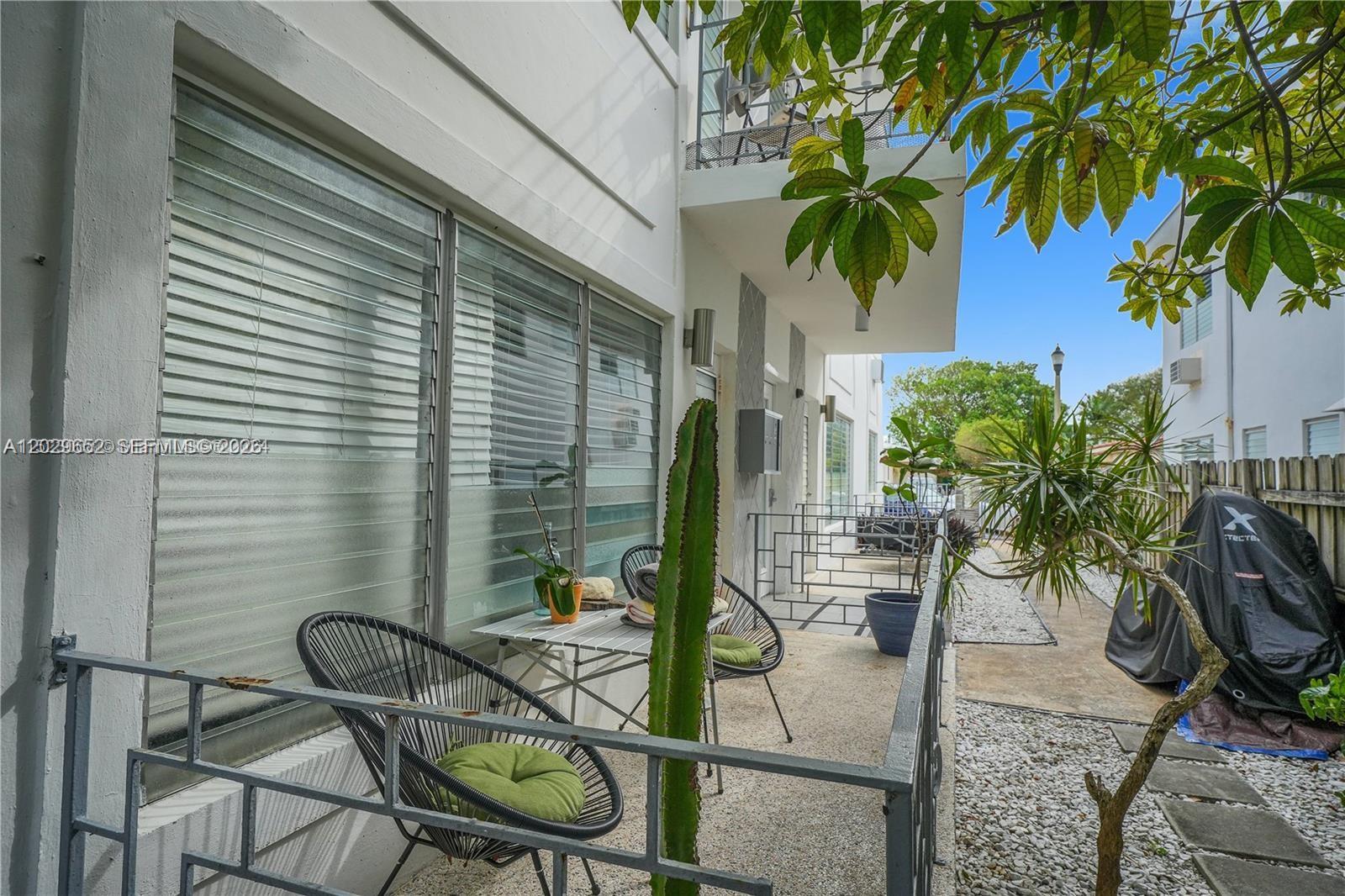 855 80th Street, Unit 4 Miami Beach, FL 33141 - Photo 16 of 16 a view of a chairs and table in patio