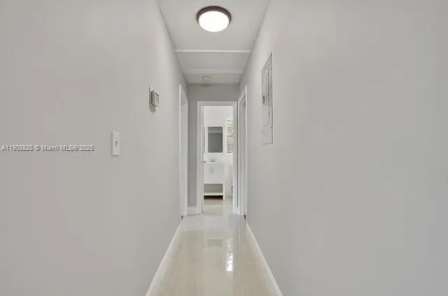 a yellow and white house with a yard