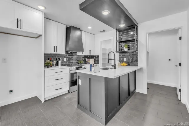 a kitchen with sink cabinets and stove