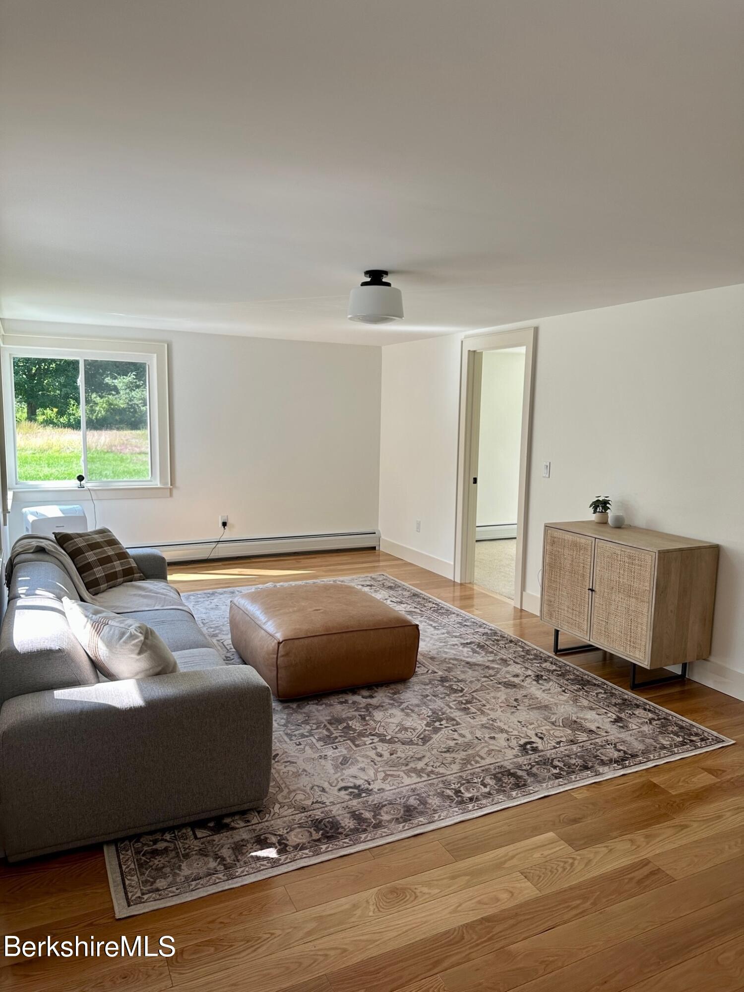 5 Cherry Hill Road Stockbridge, MA 01262 - Photo 15 of 39 a living room with a couch and a rug