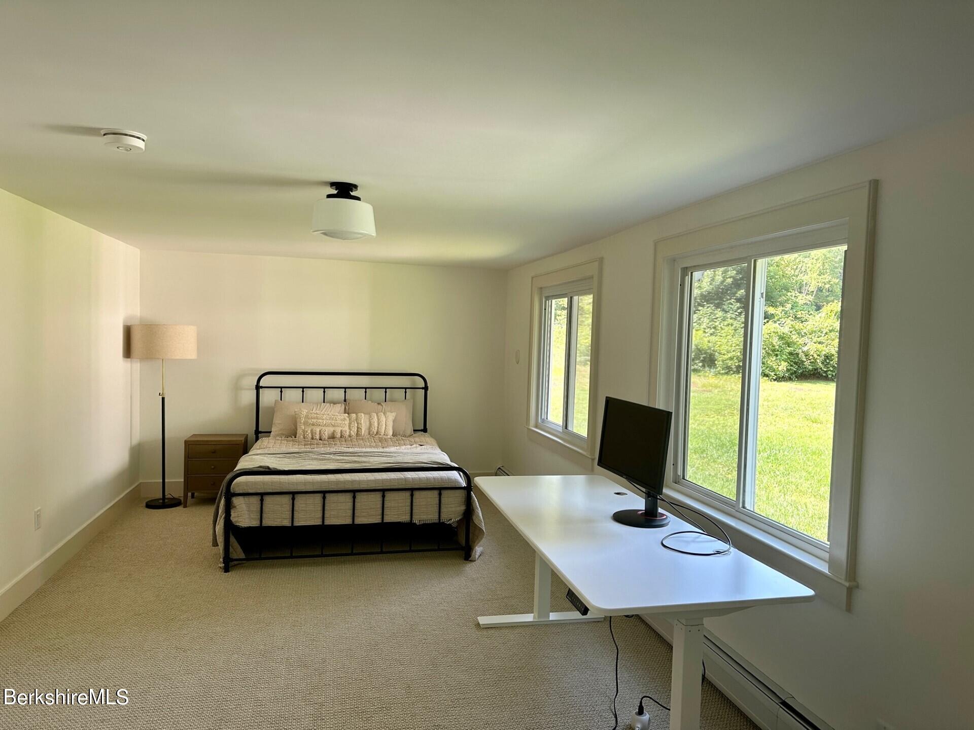 5 Cherry Hill Road Stockbridge, MA 01262 - Photo 19 of 39 a bedroom with a bed window and a table