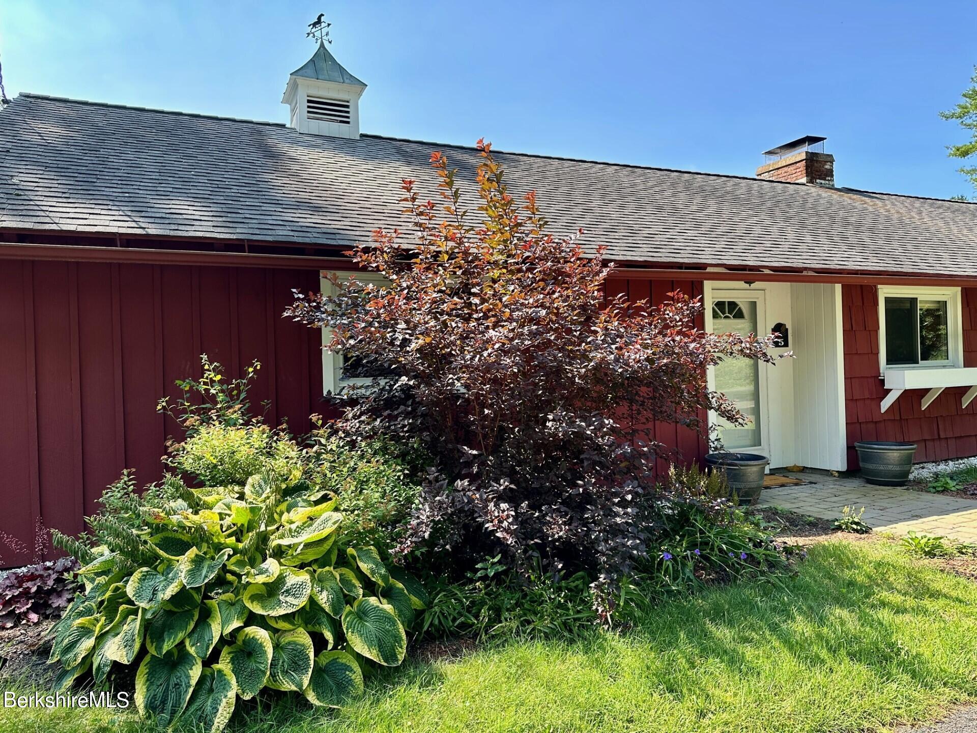 5 Cherry Hill Road Stockbridge, MA 01262 - Photo 36 of 39 a view of a house with a flower garden