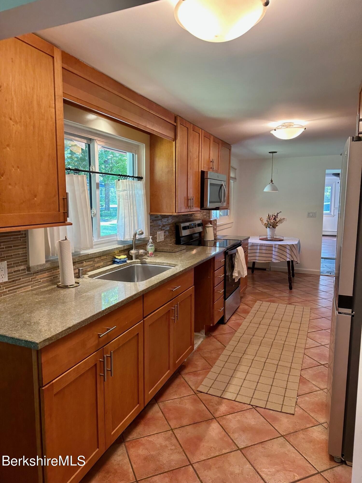 5 Cherry Hill Road Stockbridge, MA 01262 - Photo 8 of 39 a large kitchen with stainless steel appliances granite countertop a sink counter space cabinets and a large window