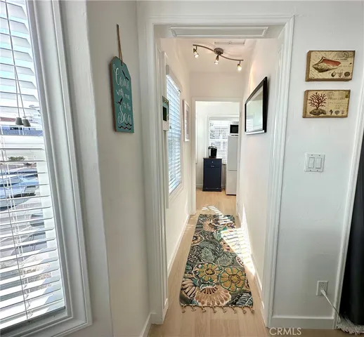 a view of bedroom with window and hallway