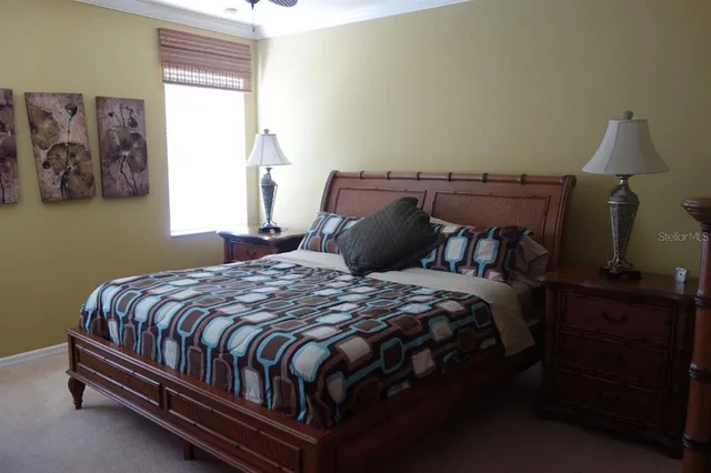 a bedroom with a bed lamp and a window