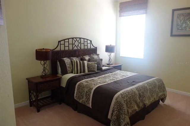 a bedroom with bed and a window