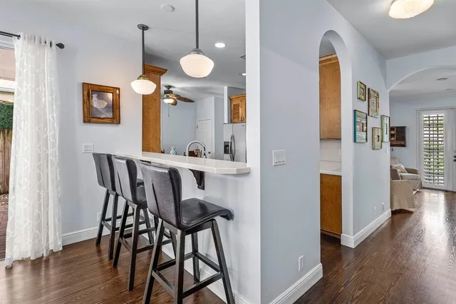 an empty room with wooden floor and mirror
