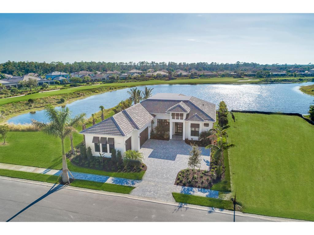 9828 Montiano Place Naples, FL 34113 - Photo 2 of 18 a view of a house with outdoor space and a lake view