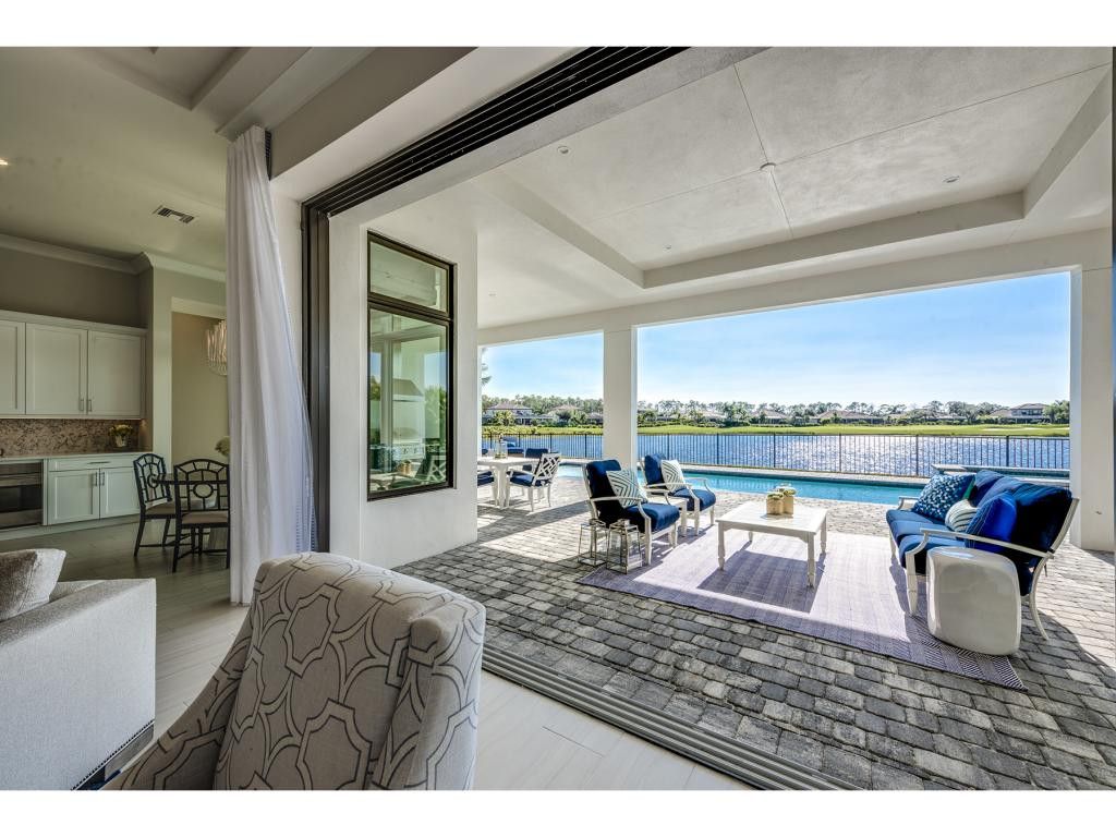 9828 Montiano Place Naples, FL 34113 - Photo 12 of 18 a view of a living room and floor to ceiling window or kitchen