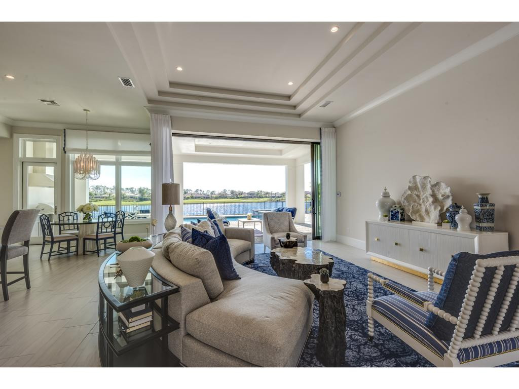 9828 Montiano Place Naples, FL 34113 - Photo 14 of 18 a living room with furniture and a large window