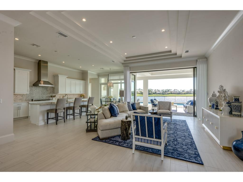 9828 Montiano Place Naples, FL 34113 - Photo 16 of 18 a living room with furniture and a large window