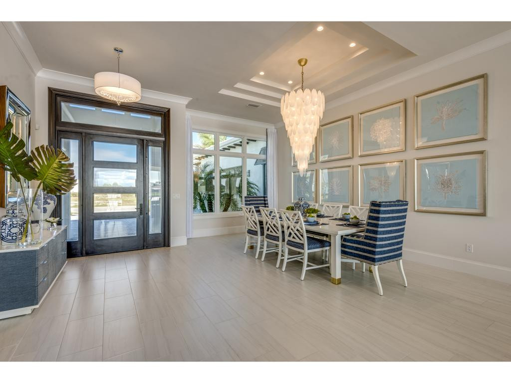 9828 Montiano Place Naples, FL 34113 - Photo 17 of 18 a dining room with furniture window and wooden floor