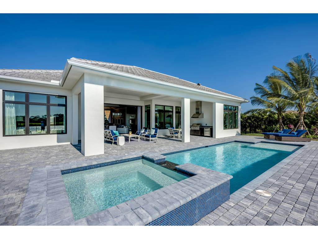 9828 Montiano Place Naples, FL 34113 - Photo 9 of 18 a view of a house with backyard porch and sitting area