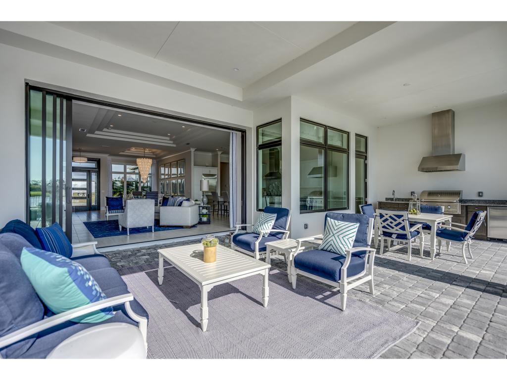 9828 Montiano Place Naples, FL 34113 - Photo 10 of 18 a living room with furniture and a large window