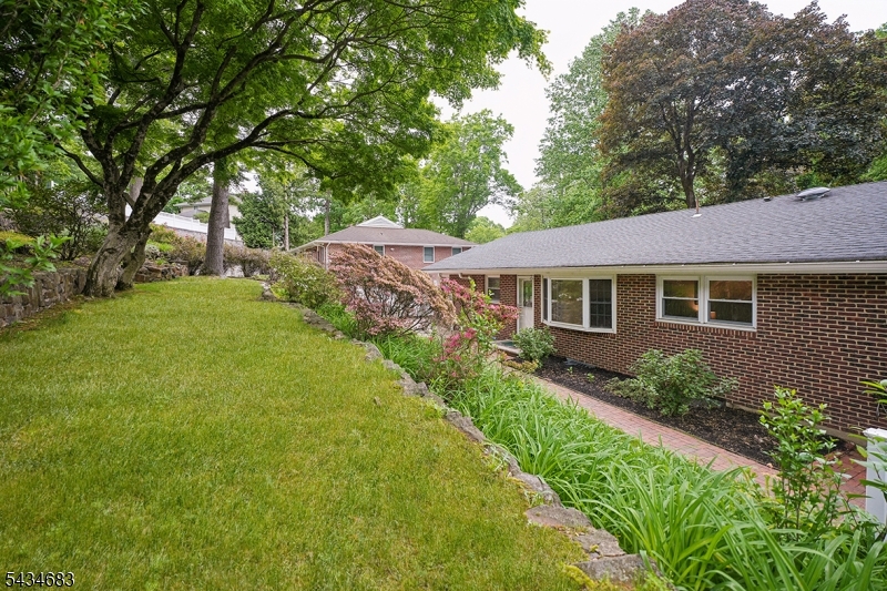 106 Division Avenue Summit, NJ 07901 - Photo 36 of 38 a aerial view of a house with yard and green space