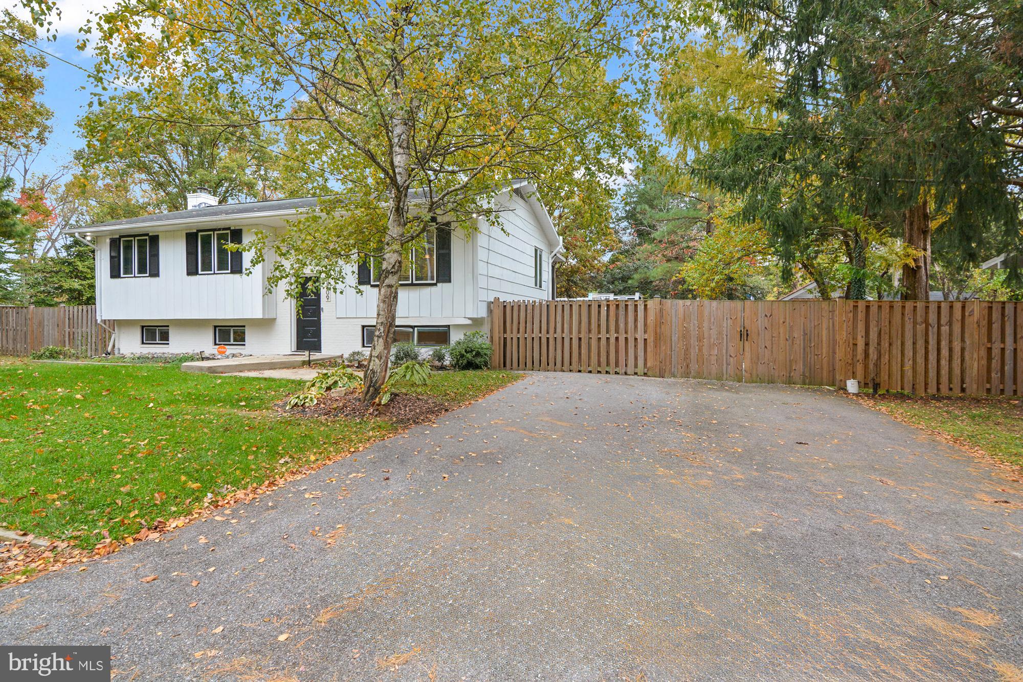 a front view of house with yard and trees