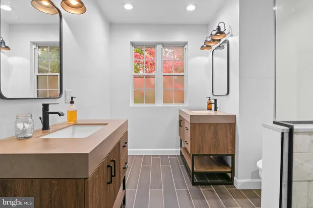 a bathroom with a sink toilet and mirror