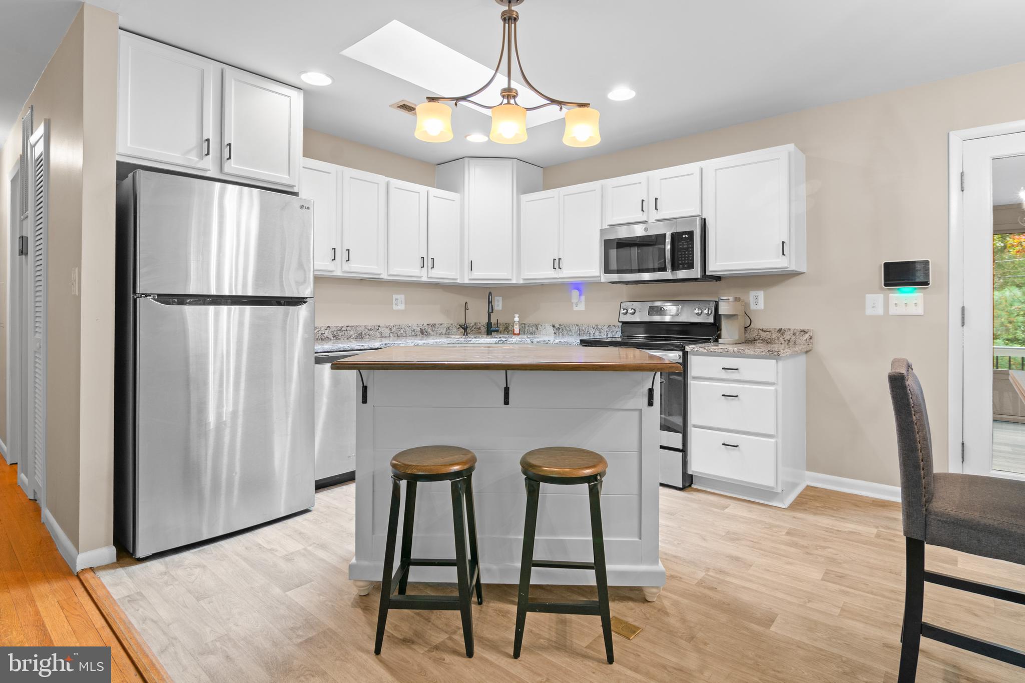 2709 Parkview Drive Riva, MD 21140 - Photo 6 of 53 a kitchen with stainless steel appliances granite countertop a refrigerator a stove a sink dishwasher and white cabinets with wooden floor