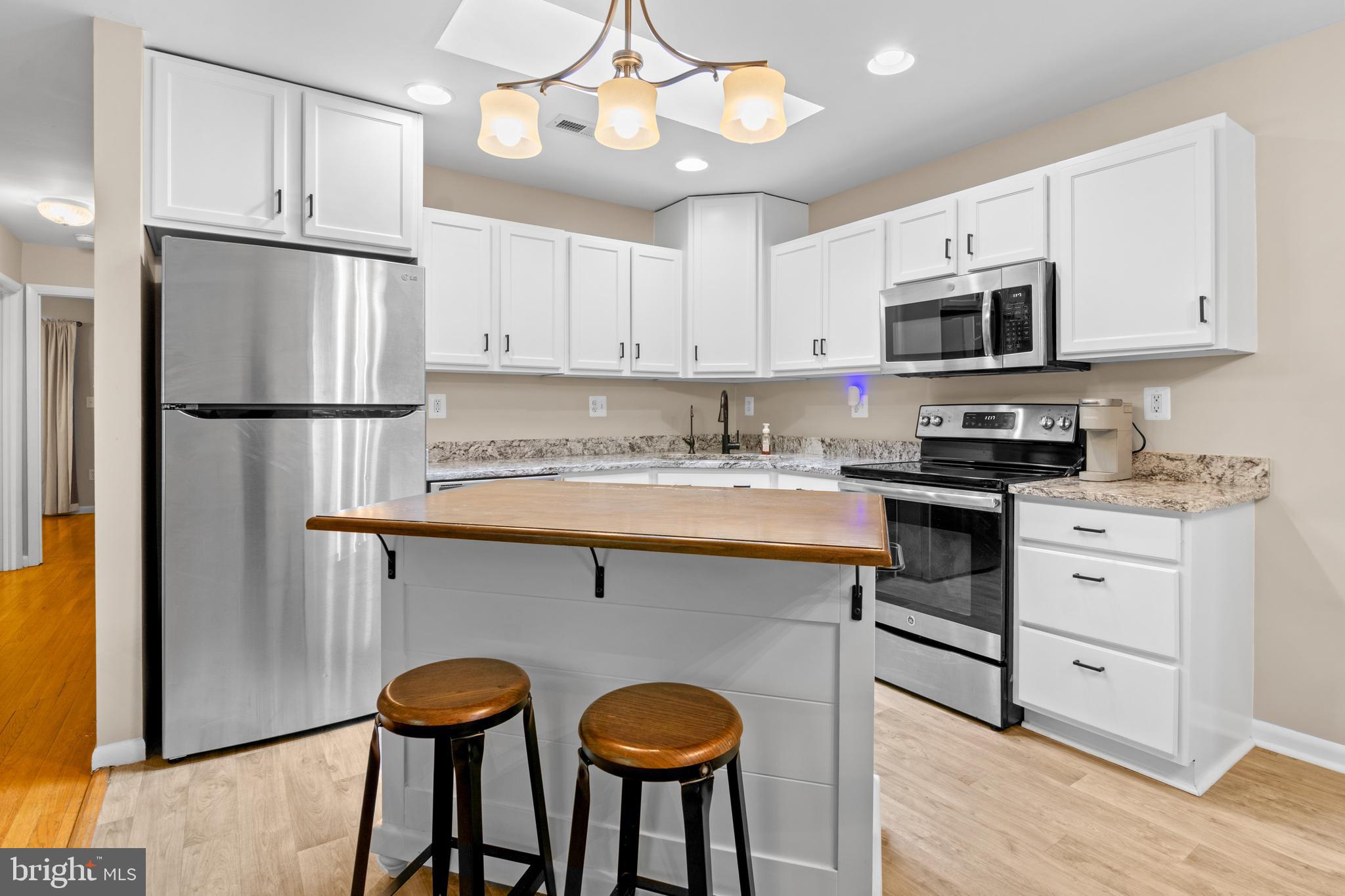 2709 Parkview Drive Riva, MD 21140 - Photo 7 of 53 a kitchen with stainless steel appliances granite countertop a refrigerator a sink dishwasher a stove and white cabinets with wooden floor
