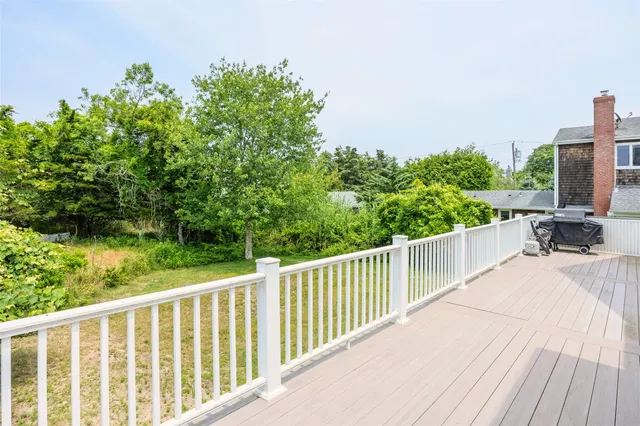 a balcony with wooden floor and outdoor space