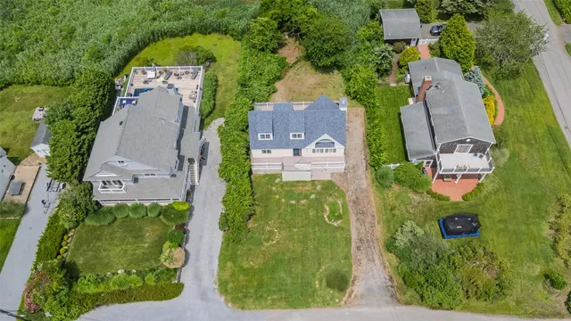 an aerial view of residential house with outdoor space and parking