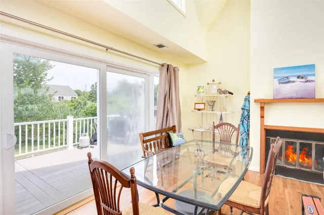a dining room with furniture a rug and wooden floor