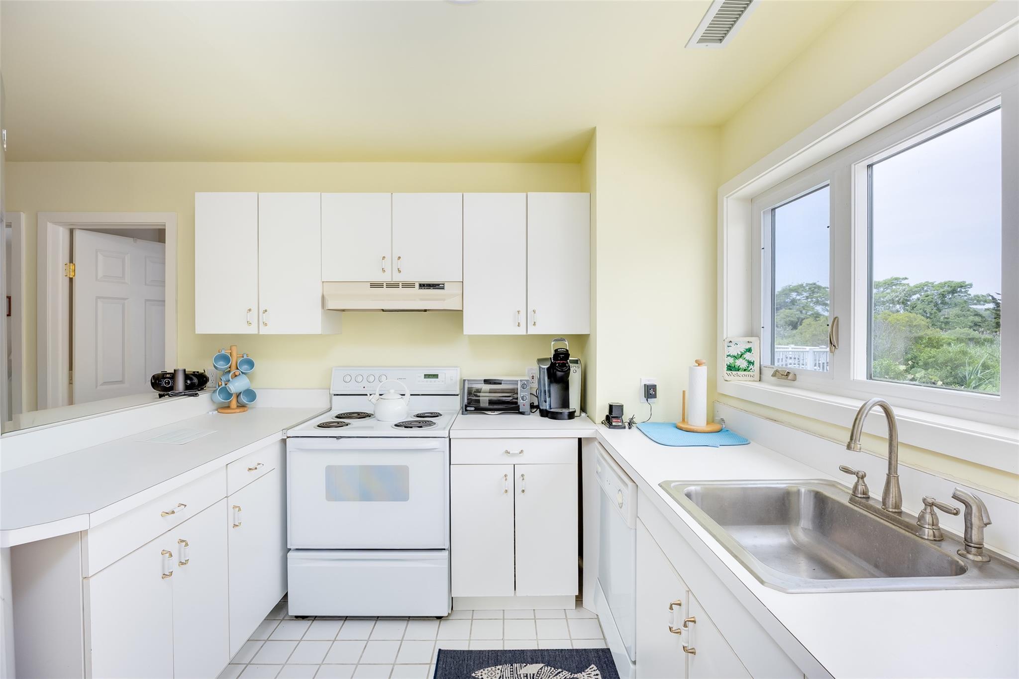10 Bayview Road Remsenburg, NY 11960 - Photo 30 of 47 a kitchen with a sink stove top oven and cabinets