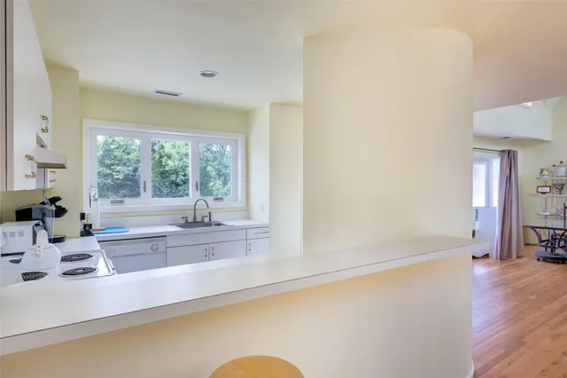 a view of a kitchen with a sink and a window