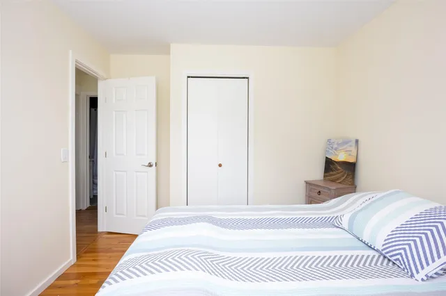 a bedroom with a bed and a mirror