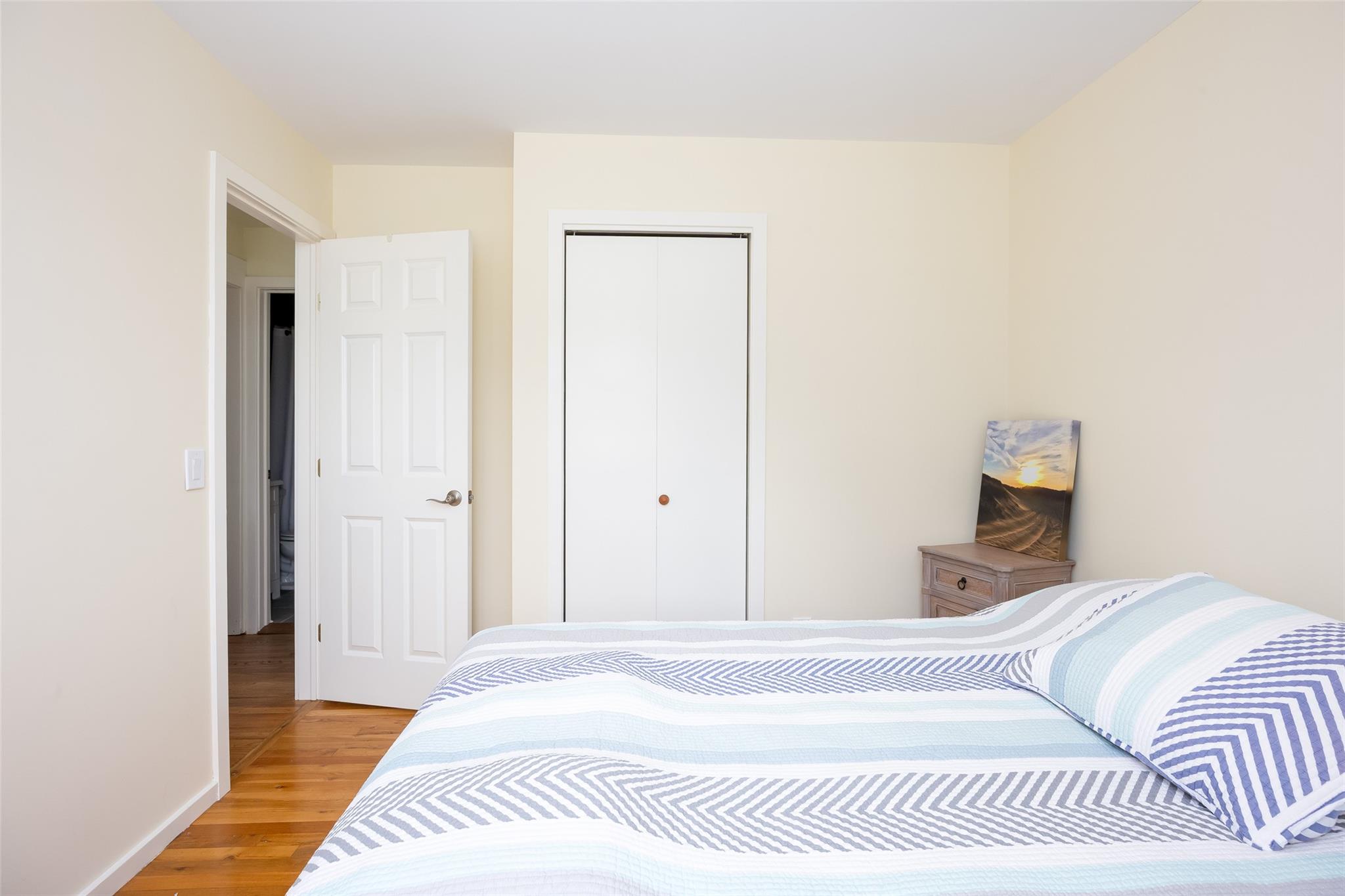 10 Bayview Road Remsenburg, NY 11960 - Photo 34 of 47 a bedroom with a bed and a mirror