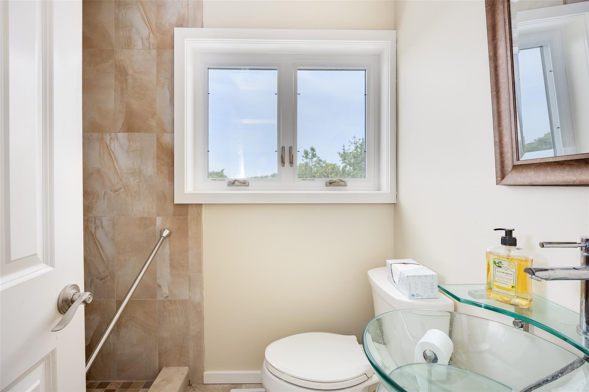 10 Bayview Road Remsenburg, NY 11960 - Photo 40 of 47 a white toilet sitting next to a bathroom sink