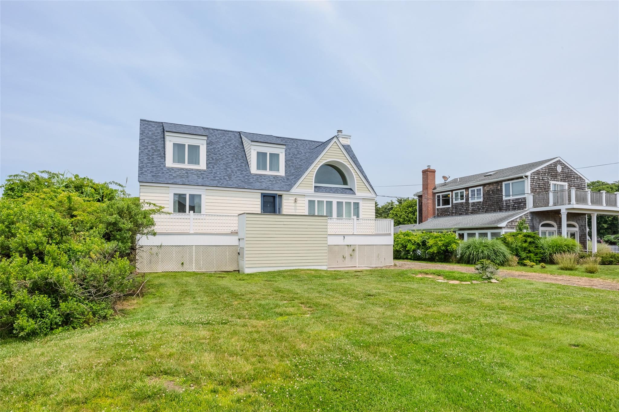 10 Bayview Road Remsenburg, NY 11960 - Photo 4 of 47 a view of a house next to a big yard and large trees