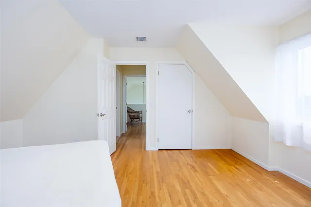 a view of a room with wooden floor